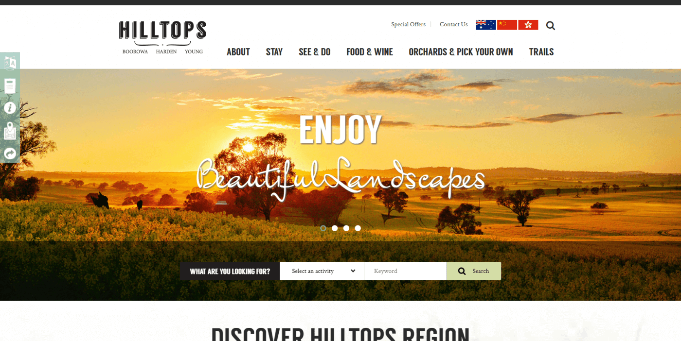 Sunset over rolling hills and fields with scattered trees in the Hilltops region.