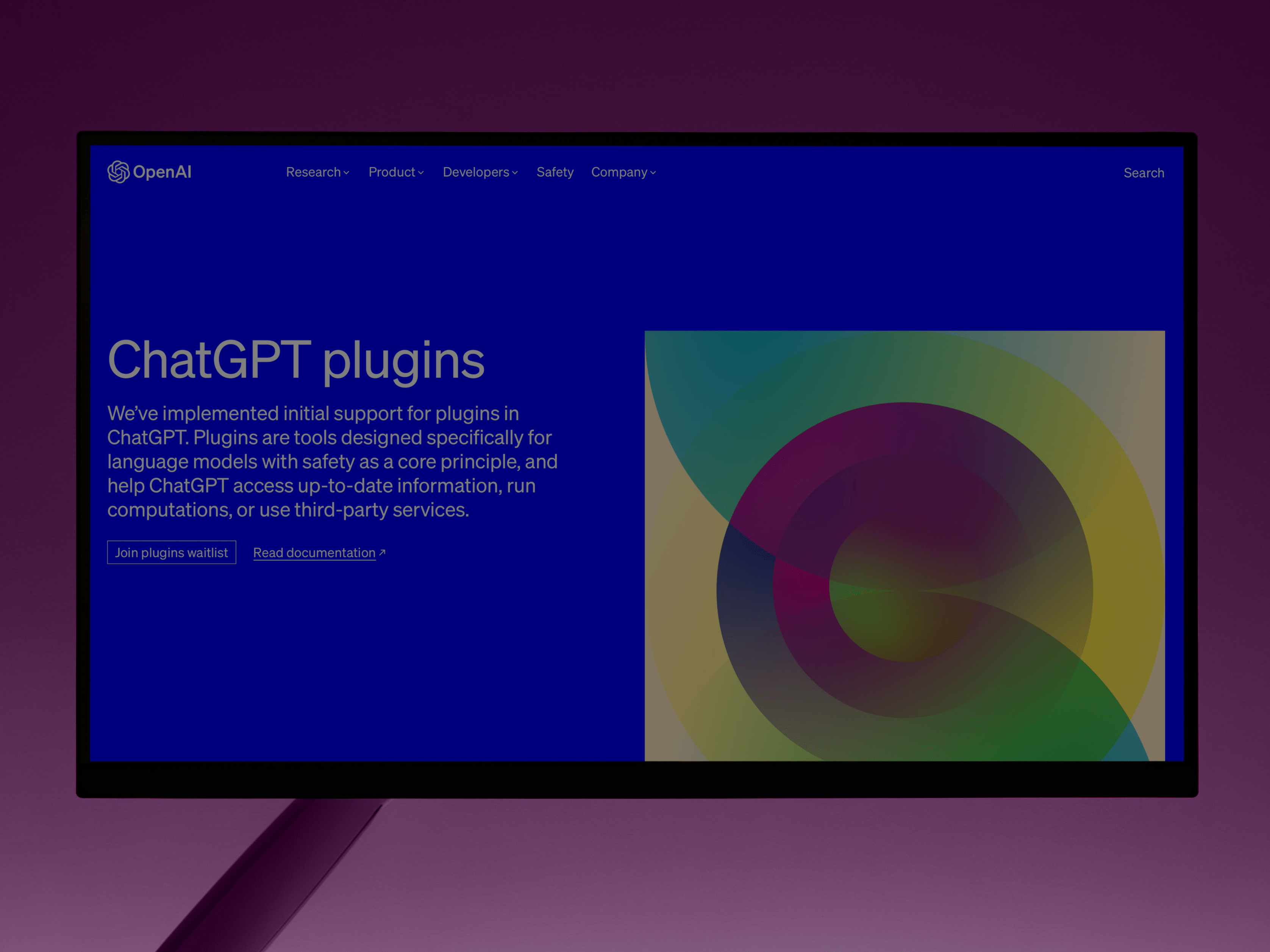 Computer screen showing the OpenAI webpage introducing ChatGPT plugins with a colorful abstract graphic.