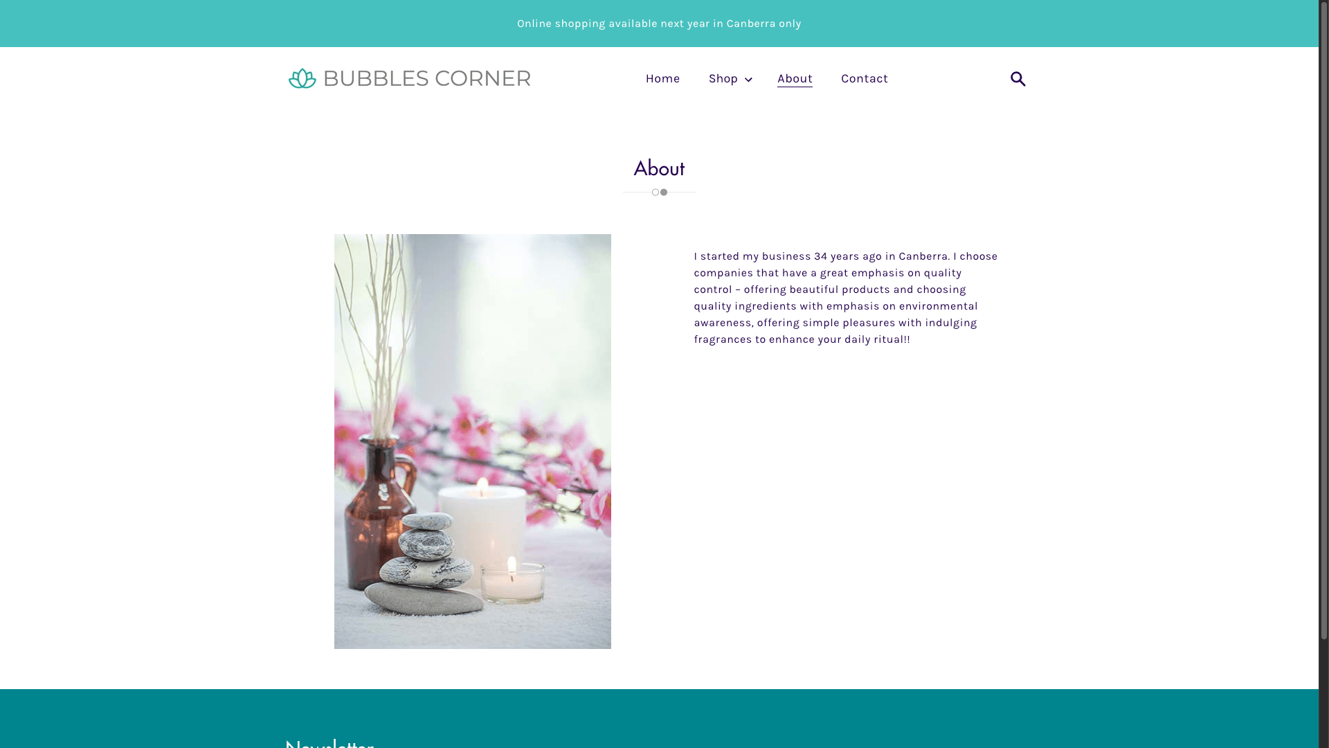 Alt text: Aromatherapy setup with candles, smooth stones, and a brown vase with dried sticks.