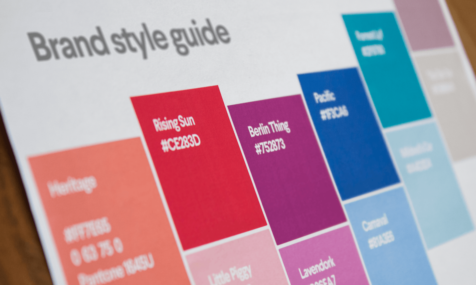 Close-up of brand style guide with color swatches and hex codes for design reference, showcasing brand style guide examples.