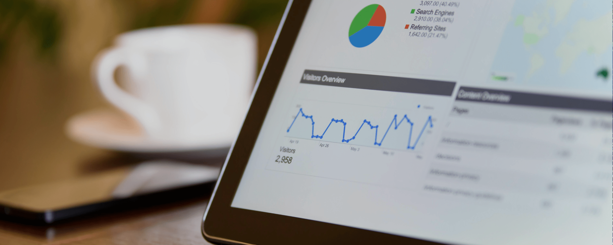 Tablet showing AI-driven SEO statistics with smartphone and coffee cup on wooden table, emphasizing AI SEO optimization an...